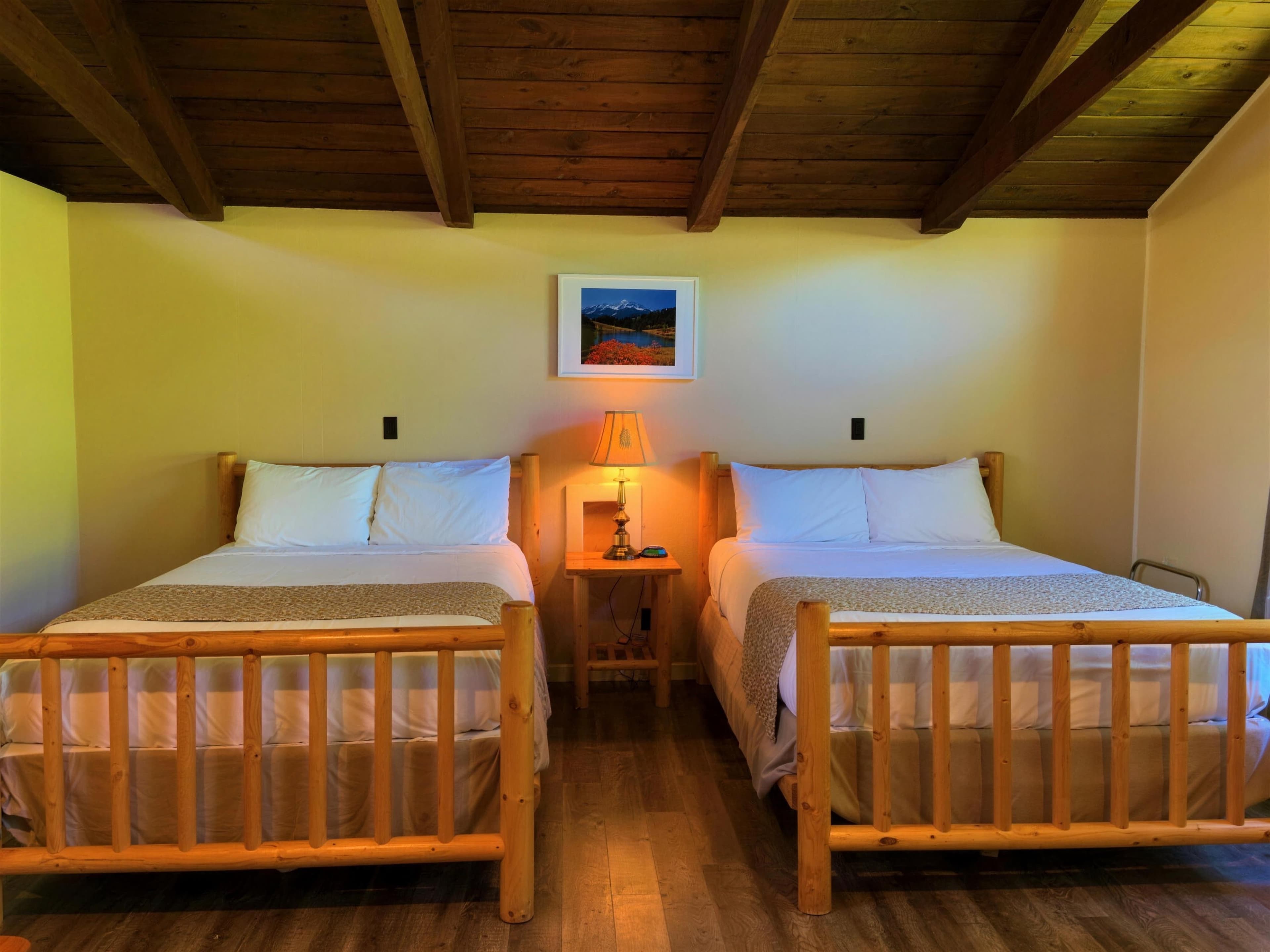 Double Room — two queens under the wood ceiling