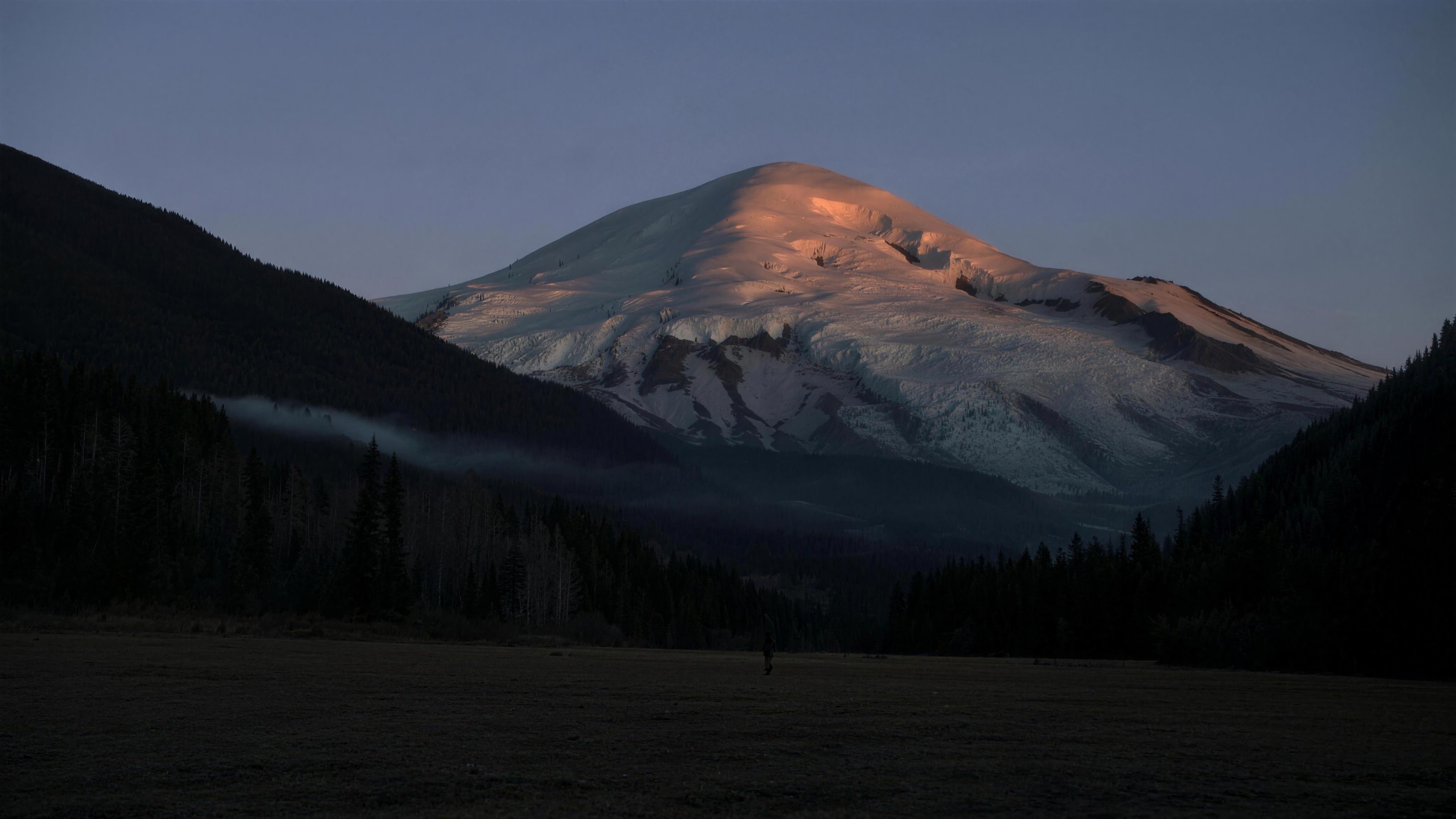 Mount Rainier glowing at dusk above the Packwood valley