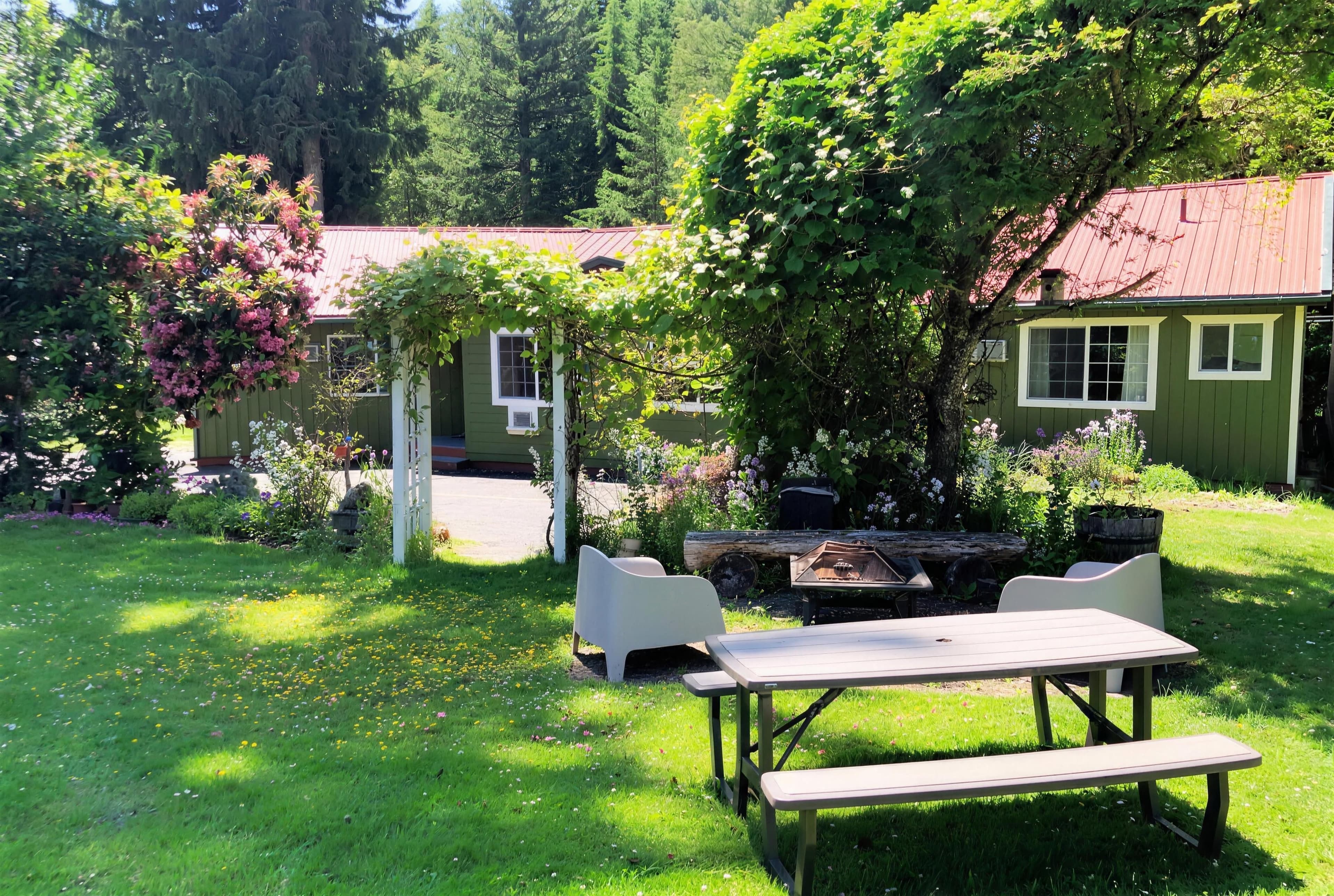 The pine garden — picnic table, arbor and cabins